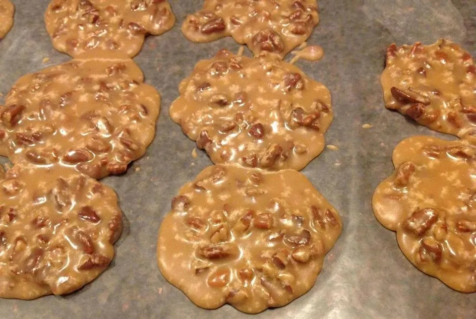 Freshly baked peanut butter cookies cooling on a tray.